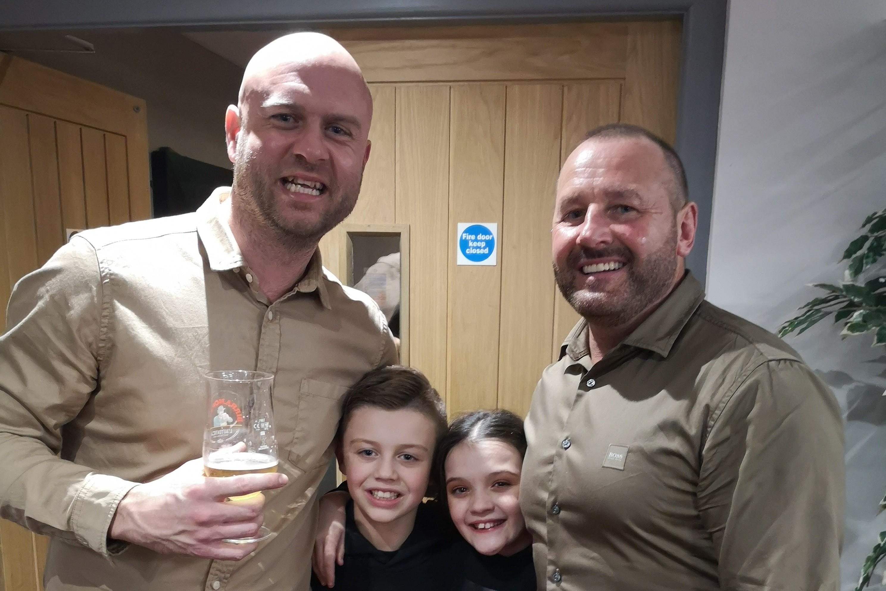 Joseph and Lily with their dads, Phil and Gary.