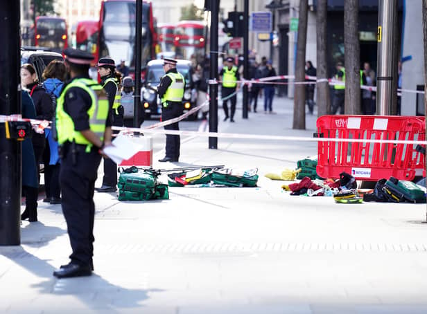 <p>Police officers at the scene after three people have been taken to hospital following reports of stabbings at Bishopsgate in London. Picture date: Thursday October 6, 2022.</p>