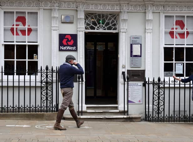 <p>Customers use a NatWest bank on the High Street in Winchester, south west England on March 31, 2021. (Photo by ADRIAN DENNIS / AFP) (Photo by ADRIAN DENNIS/AFP via Getty Images)</p>