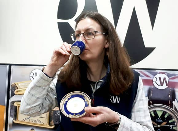 A rare cup and saucer thought to have been used by passengers on the Titanic has sold for thousands at auction