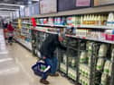 A customer shops for milk inside a Sainsbury's supermarket in east London on February 20, 2023.