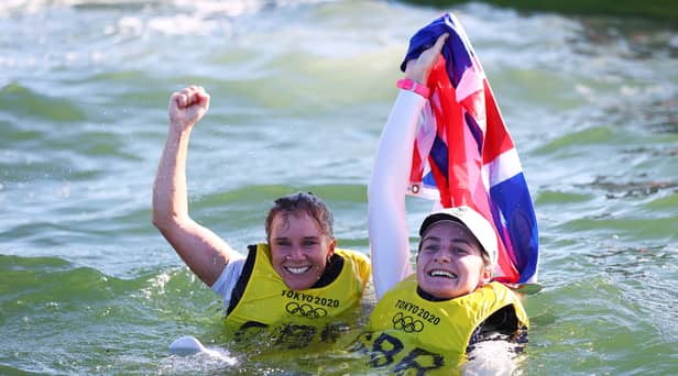 Hannah Mills (L) and Eilidh McIntyre of Team Great Britain celebrate following the Women's 470 class medal race on day twelve of the Tokyo 2020 Olympic Games (Photo by Clive Mason/Getty Images)