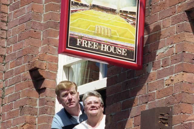 Publicans Margaret Calvert and Norman Pounder with the new sign showing a floodlit Roker Park in the Cambridge pub.
