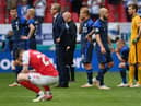 Markku Kanerva, Head Coach of Finland and Teemu Pukki of Finland wait on the pitch as Christian Eriksen (Not pictured) of Denmark receives medical treatment during the UEFA Euro 2020 Championship Group B match between Denmark and Finland on June 12, 2021 in Copenhagen, Denmark. (Photo by Stuart Franklin/Getty Images)
