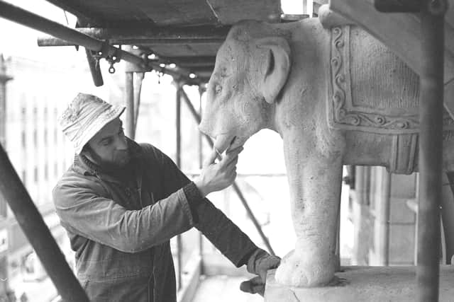 Ornamental mason John Edwards inspects a stone elephant before beginning "plastic surgery".