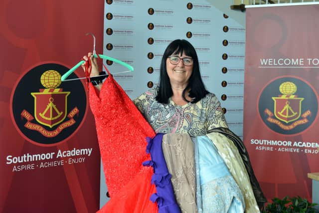 Teaching assistant Nikki Snaith with some of the donated prom dresses.