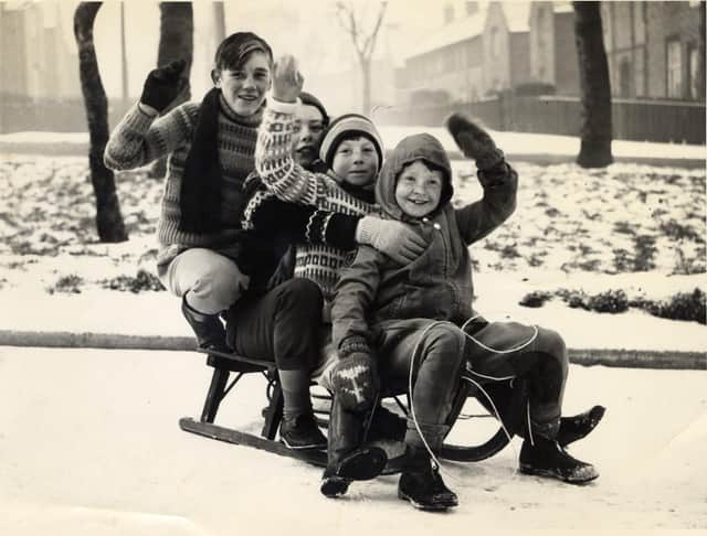 Four children enjoy fun in the snow at Christmas in 1961. From front to back are: Dorothy Grater, seven, David Stewart, nine, his brother John Stewart, 13, and David Gibson, 14. Young David grew up to become pop star Dave Stewart.