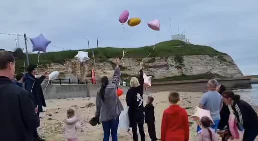 Family and friends of Michelle Hanson release balloons on Roker beach. 