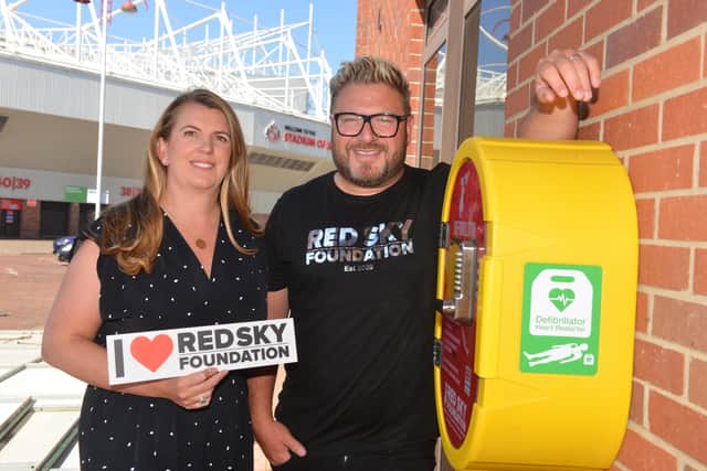 Sergio and Emma Petrucci with the Red Sky Foundation's latest defibrillator, installed at the Stadium of Light