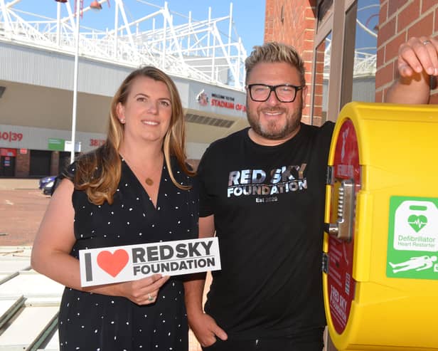 Sergio and Emma Petrucci with the new Red Sky Foundation defibrillator at Black Cat House
