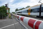 A CCTV clip has shown the heart-stopping moment a woman has a near miss with a train on a level crossing
