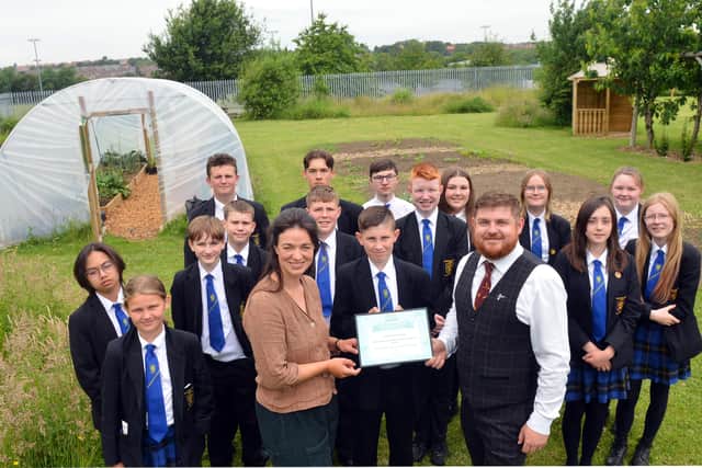 TV horticulturist Frances Tophill presents Sandhill View Academy allotment lead Aidan Hodgson and students with the Royal Horticultural Society's School Gardening Team of the Year award.