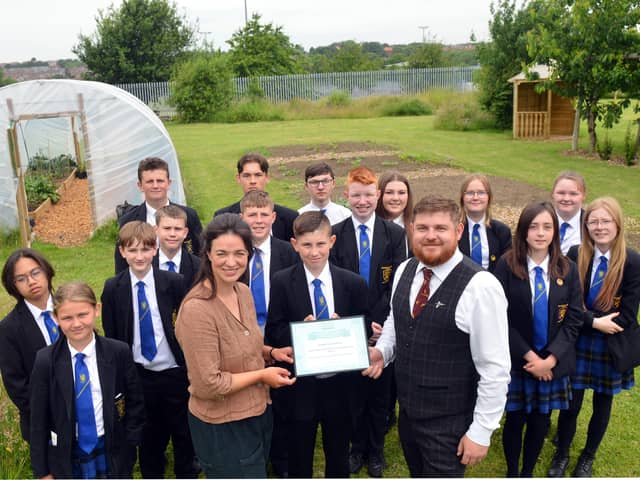 TV horticulturist Frances Tophill presents Sandhill View Academy allotment lead Aidan Hodgson and students with the Royal Horticultural Society's School Gardening Team of the Year award.