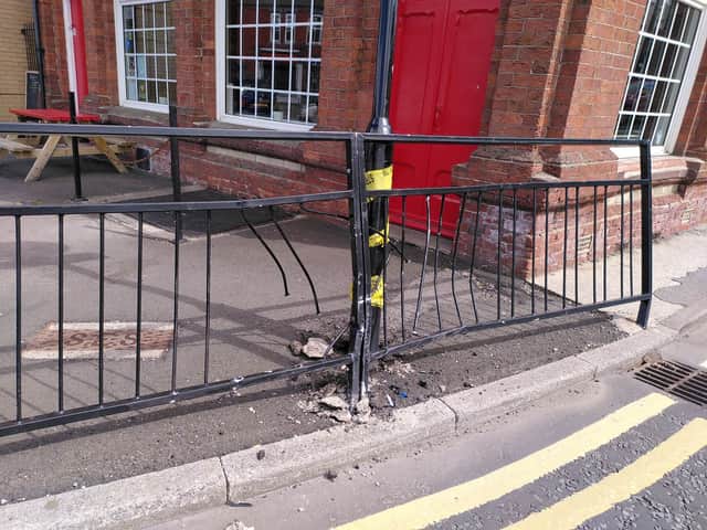 A damaged crash barrier and sign at The Cambridge.