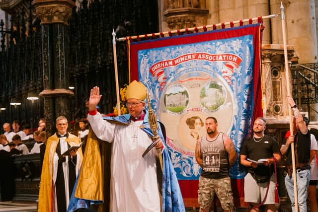 The Bishop of Durham blessing a banner at the 2022 service.