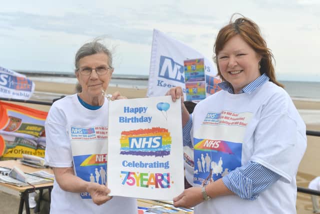 Retired GP Pam Wortley and Laura Murrell from KONP with the NHS birthday card.