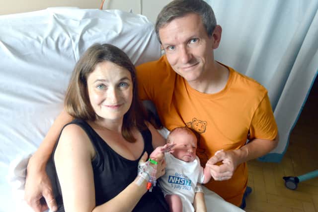 Sarah Peacock and Darren Phillips with their new baby boy, born on the 75th anniversary of the NHS