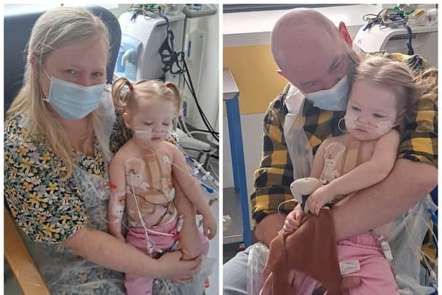 Hugs from mum and dad for heart transplant girl Beatrix Archbold.