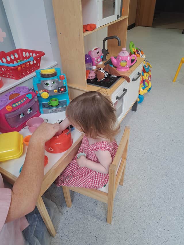 Beatrix has fun in the hospital play room.