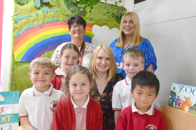 Debra Stockdale is joined by staff and children to celebrate her retirement.