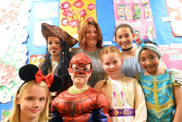 Headteacher Tracey Pizl with some of the children dressed in Disney fancy dress.