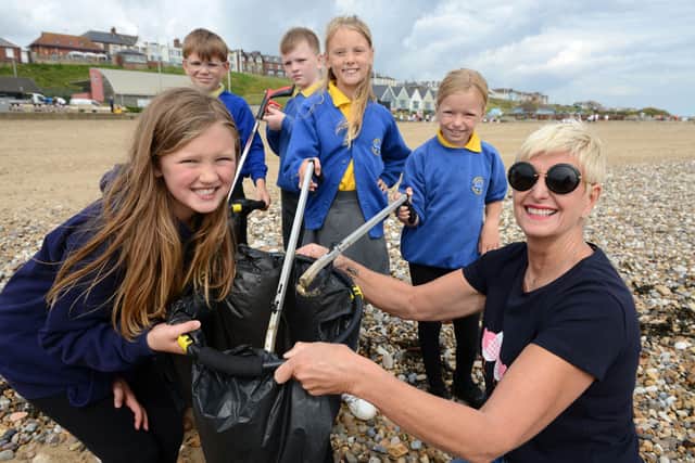 Year 4 pupils from Dame Dorothy Primary School and Sue Taggart from Sue's Café at the beach clean. Picture by Sunderland City Council.