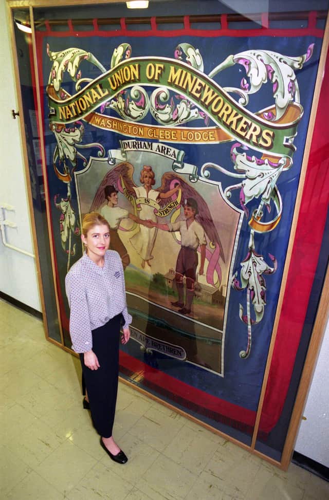 Victoria Medhurst, senior assistant at Washington town centre library, with the restored Glebe miners' banner.
