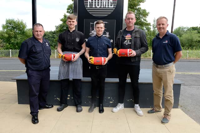 (left to right) Firefighter Tommy Richardson of TWFRS, Chef Tyler Wemyss, General Manager Mark Halliday, patron Matthew Cadas and Tony Wafer, Senior Water Safety Manager, RNLI.  They are pictured holding throwbags outside of The River Bar. Picture c/o TWFRS.