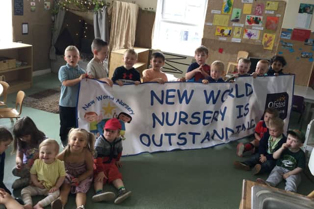 Children at New World Nursery celebrate their outstanding Ofsted judgement.