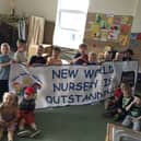 Children at New World Nursery celebrate their outstanding Ofsted judgement.