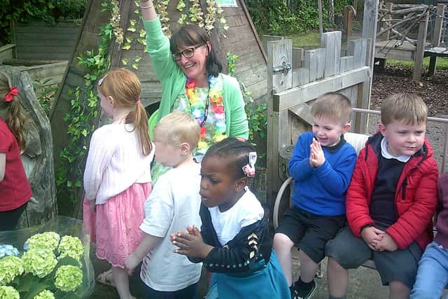 Retiring headteacher Claire Nicholson with children at the nursery.
