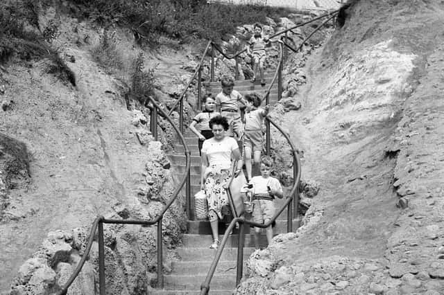 A summer scene as all the family heads to the beach in 1956.