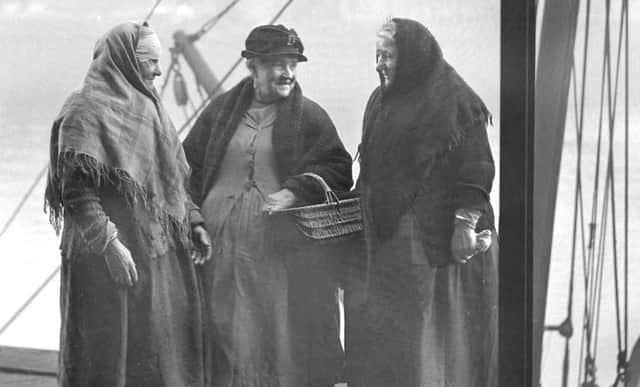  Anne Crane, Dorothy Maddison and Maggie O'Hare discuss the fine morning as they wait for the fish to be auctioned at the Fish Quay in 1939.