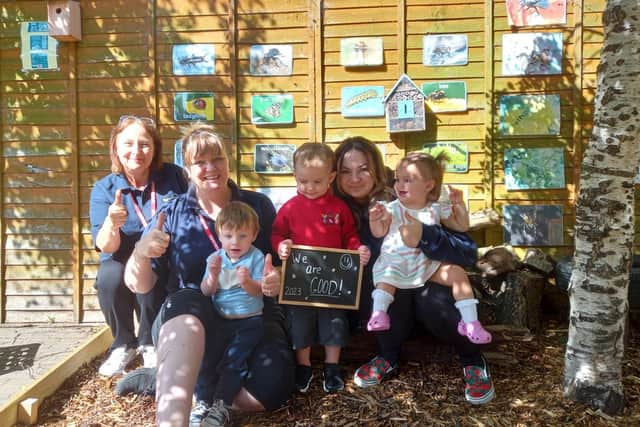 (left to right) Sandra Bolton, nursery manager Marie Hunter, and Caitlain Armes celebrate their good Ofsted with the children..