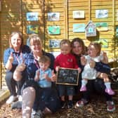 (left to right) Sandra Bolton, nursery manager Marie Hunter, and Caitlain Armes celebrate their good Ofsted with the children.
