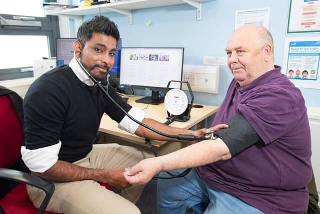 Dr Raj Bethapudi with patient Richard, 67, checking his blood pressure. Picture c/o ICB.