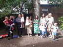 Samantha Smith (centre) with some of the parents and children from Little Acorns Preschool Nursery.
