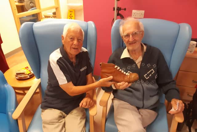 Fans Museum member Wilf Chiles (left) and patient Bill Richardson reminisce about the old boots they used to wear.