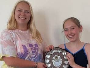 Isabella Sloens, 11, and her dance teacher Helen Tate with the trophy they won 23 years apart.