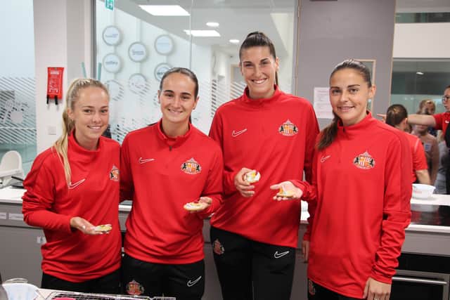 SAFC women's players Amy Goddard, Ellen Jones, Natasha Fenton and Jenna Dear show off their decorated biscuits. 