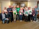 Submitted group shot of volunteers with Reverend Paul Barker (green t-shirt) getting ready for the coffee morning with promotional items from Macmillan.