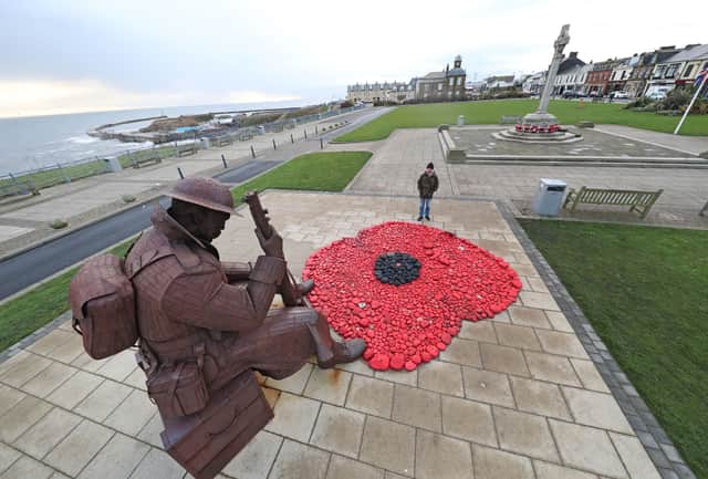 PA picture of David McKenna at the Tommy statue for a previous Armistice Day project.