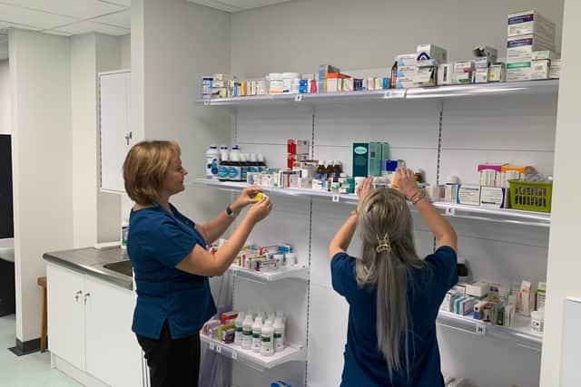 Staff selecting stock from the shelves of the new pharmacy space at Sunderland Royal Hospital