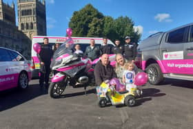 Beatrix Archbold, 2, with parents Terry and Cheryl and representatives from the police, NHS and North East Ambulance Service.