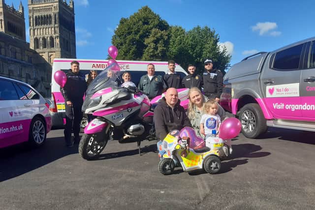 Beatrix Archbold, two, with parents Terry and Cheryl and representatives from the police, NHS and North East Ambulance Service.