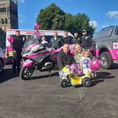 Beatrix Archbold, 2, with parents Terry and Cheryl and representatives from the police, NHS and North East Ambulance Service.