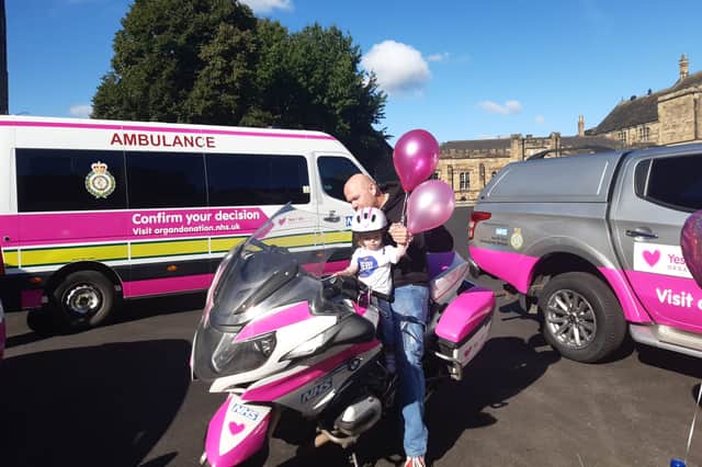 Beatrix with her dad Terry on a police motorbike which is one of four emergency services vehicles promoting the importance of registering for organ donation.