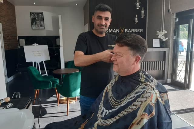 Barber Selcuk Boybay with customer Brian Donaldson.