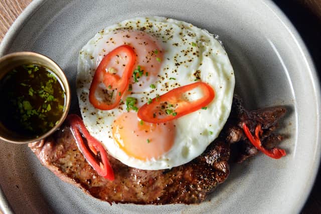 Minute steak with fried eggs and chimichurri