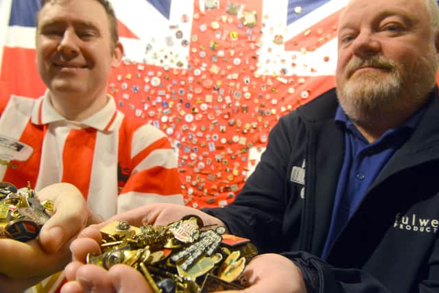 Fans' Museum founder Michael Ganley receives over 500 badges from Stuart Arthur, from his deceased father Keith Arthur's collection.